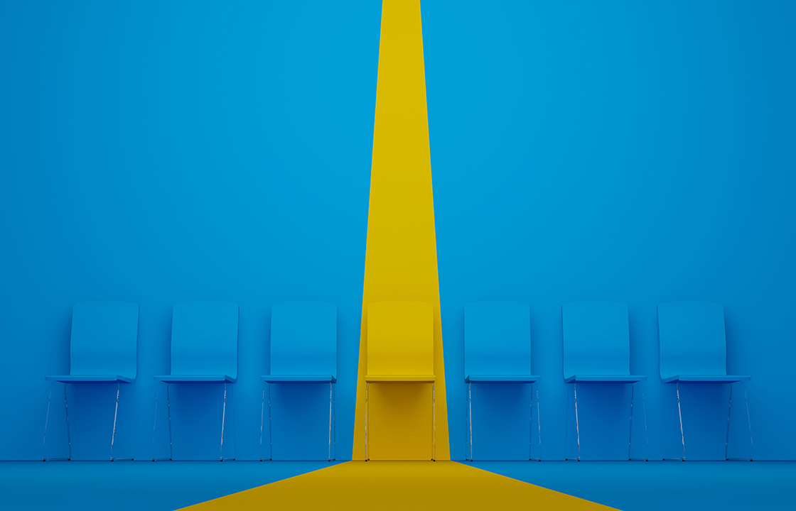 row of chairs in blue with one standing out in yellow