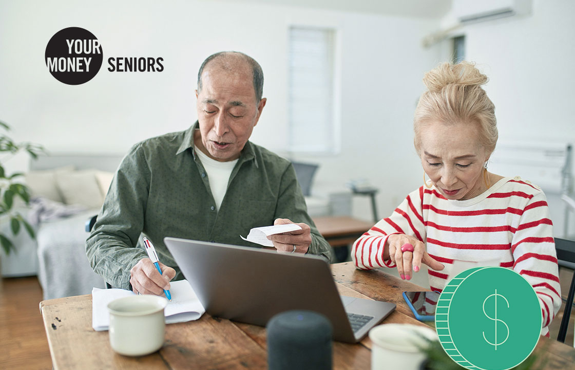 senior couple going over finances in front of computer
