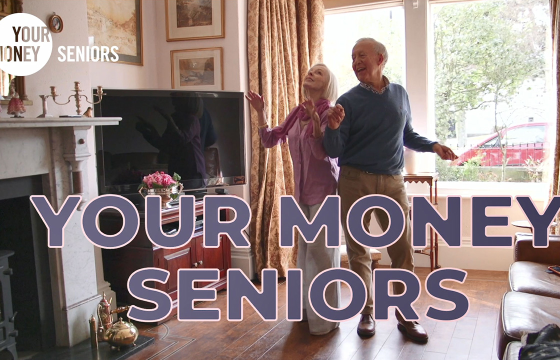 senior couple dancing in their living room