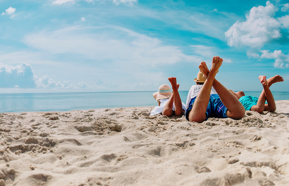 decorative image of a family laying on the beach