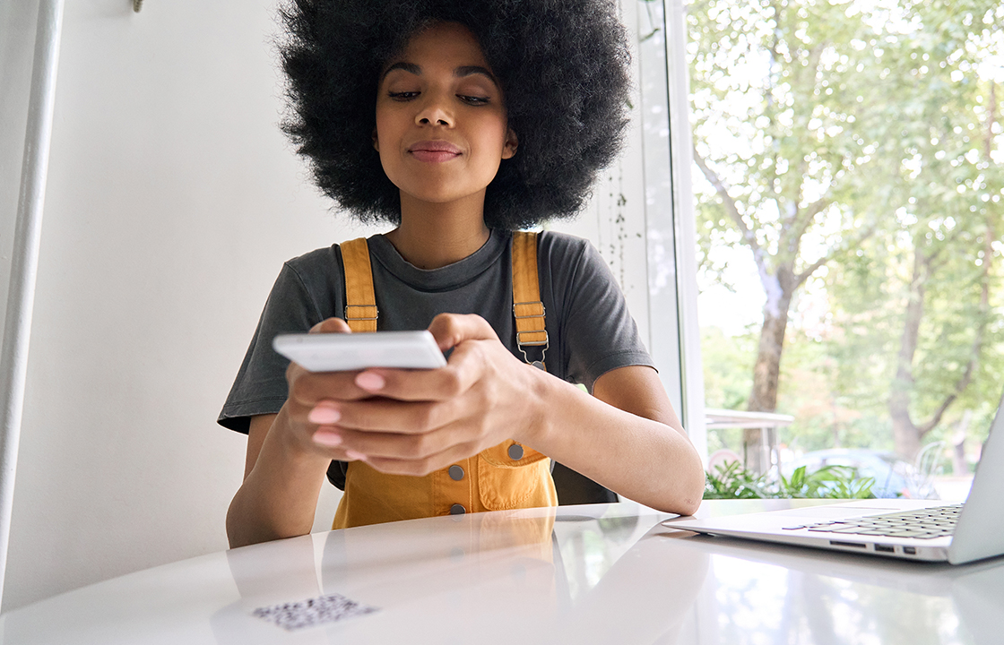 woman scanning a qr code with her mobile phone