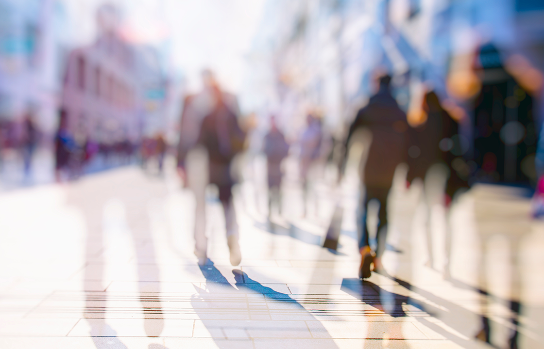 people walking on a busy sidewalk